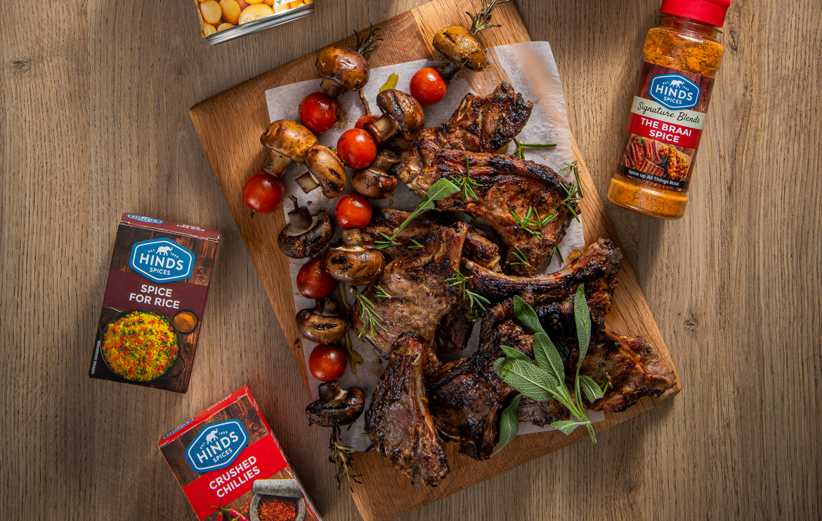 Braai yoghurt, garlic and herb marinated lamb chops with rosemary skewers and a fresh rice and bean salad. A flavour-packed South African braai recipe.